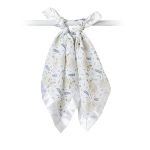 Lulujo Inc.s Security Blanket, Koala: a breathable white muslin swaddle with a subtle leaf pattern, elegantly tied around a rod.