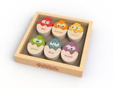 The Color N Eggs by Begin Again is a wooden puzzle box with six cartoon bird shapes in eggshells. Each egg is labeled with a distinctive color: red, orange, yellow, green, blue, and purple—ideal for enhancing fine motor skills.