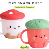 Two Itzy Ritzy snack cups: one with a red mushroom lid, the other green strawberry, both dishwasher-safe and smiling.