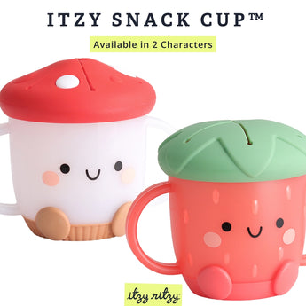 Two Itzy Ritzy snack cups are pictured with cute faces and handles: one is a white mushroom with a red top, the other, a red strawberry with a green top. The Itzy Snack Cup™ has a silicone lid, is dishwasher-safe, and comes in these 2 charming characters.