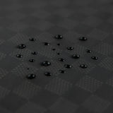 Close-up of water droplets on the Bumkins Wet/Dry Clutch: Rich Black waterproof fabric.