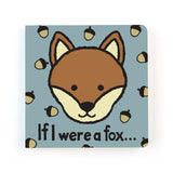 The chunky board book cover from Jellycat, If I Were a Fox, displays a cheeky fox cub’s face encircled by playful acorns on a blue background, inviting children to a whimsical woodland adventure.