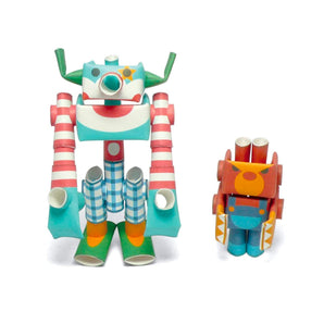 Two colorful paper robots from the Magnote Piperoid Circus Duo 3D craft kit on a white background, with cylindrical limbs and cartoon faces.