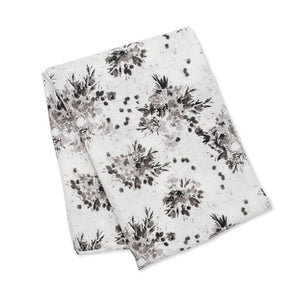 The extra-large Bamboo Swaddle by Lulujo Inc. features a neat black floral design, perfect for versatile use.