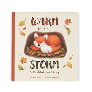 The Jellycat, Warm in the Storm Book: A sleeping fox on leaves amid autumn hues. A perfect bedtime story from Jellycat.