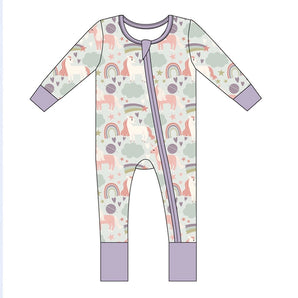 The Emerson and Friends Sleeper, Magical Unicorns is a buttery soft baby onesie made from bamboo with a whimsical unicorn, rainbow, cloud, and star pattern. It features pastel colors with purple cuffs and a two-way diagonal zipper for added convenience.