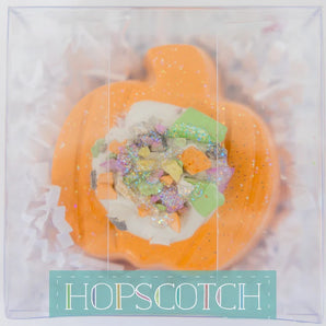 Hopscotchs Sidewalk Chalk, Pumpkin is pumpkin-shaped and bright-colored, with glitter on top in clear wrap.