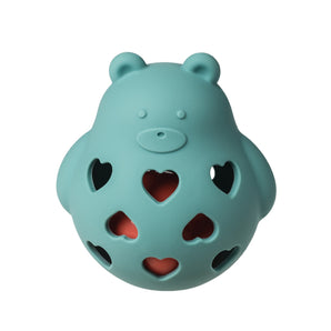 Roly Rattle by Mary Meyer: A blue bear-shaped teether with heart holes, made from food-safe silicone showing a red layer inside.