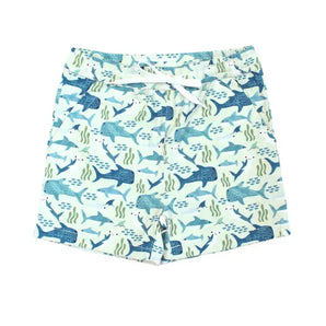 Emerson and Friends Shark Friends swim trunks feature a vibrant blue and teal shark and seaweed pattern on light green fabric, perfect for summer adventures. They include an adjustable white drawstring at the waist for a secure fit.