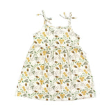 The Emerson and Friends Sundress, Happy Honey Bees design, features bees, flowers, and green leaves in yellow, brown, and green. It has thin shoulder straps and a gathered waist that creates a beautifully flowing skirt.