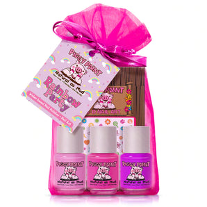 Pink gift bag with 3 bottles of Piggy Paint Rainbow Party polish and a colorful tag with cartoon pigs and rainbows.