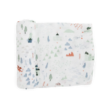 Little Unicorns Bamboo Swaddle, Dragon Days, features a soft rayon muslin with mountains, trees, castles, clouds & a red dragon.