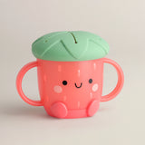 The Itzy Ritzy Itzy Snack Cup is a cute strawberry-shaped sippy cup with a silicone lid, leaf top, and easy-grip handles.