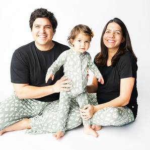 A smiling family wears Emerson and Friends Stay Sharp bamboo lounge pants featuring a cactus pattern on a white background.