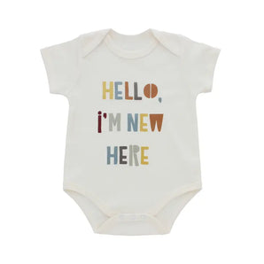 Cream luxury cotton bodysuit for babies, by Emerson and Friends, features HELLO, IM NEW HERE in colorful text.