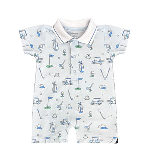 The Noomie Golf Romper features clubs, carts, and flags on a pale base with blue and green accents in Pima cotton.