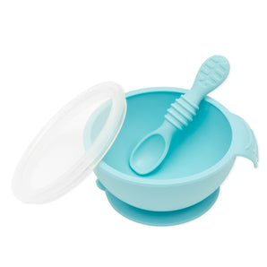 The Bumkins Silicone First Feeding Set in Blue includes a suction bowl with lid and spoon, all crafted from food-safe silicone.