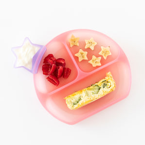 Pink plate with yogurt star cup, banana stars, strawberries, and quiche on a Bumkins Silicone Grip Dish: Pink Jelly.