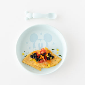 The Bumkins Silicone Plate + Spoon Set: Disney Mickey Mouse adds fun to self-feeding with an omelette, black beans, tomatoes, and peppers.