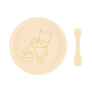 Bumkins Disney Winnie the Pooh Silicone Plate + Spoon Set in cream features a cartoon bear and honey pot design.