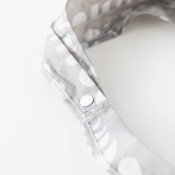 Close-up of the strap of the Bumkins Packable Tote Bag: Lunar Phase on a white background, featuring a snap closure.