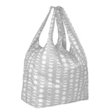 The Bumkins Packable Tote Bag: Lunar Phase features a gray backdrop with lunar phases. It has two handles and is made from lightweight, waterproof fabric for durable, stylish everyday use.