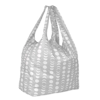 The Bumkins Packable Tote Bag: Lunar Phase features a gray backdrop with lunar phases. It has two handles and is made from lightweight, waterproof fabric for durable, stylish everyday use.