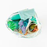 Top view of Bumkins Packable Tote Bag: Aloha Stitch on a white background, filled with swimming gear, featuring goggles, toys, and a towel.