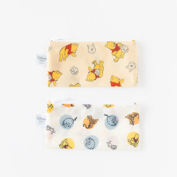 Bumkins Reusable Snack Bag, Small 2 Pack: Pooh Bear and Friends laid flat on a white background with one bag above the other.