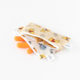 The Bumkins Reusable Snack Bag Small 2 Pack, featuring charming Pooh Bear and Friends designs on cream-colored waterproof fabric, includes one open pouch with cookies and carrots inside, plus side tags.