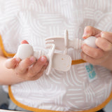 Child exploring baby-led weaning with Bumkins Silicone Chewtensils®: Sand, featuring sensory bumps for an engaging mealtime.