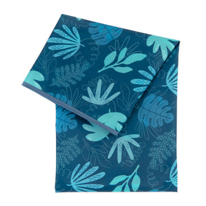 Bumkins Splat Mat: Blue Tropic features folded waterproof fabric with a blue and teal leaf pattern for easy cleaning.