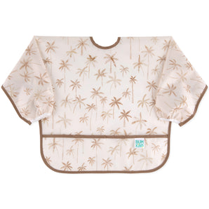 The Bumkins Sleeved Bib: Palm Daze features waterproof fabric, a light brown palm tree pattern, and a pocket—ideal for baby-led weaning.