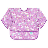 The Bumkins Sleeved Bib: Unicorns, perfect for baby-led weaning, features a purple and pink unicorn design. It has elastic cuffs, a bottom pocket for practicality in play, and is made of waterproof fabric with the brand logo on the lower left corner.