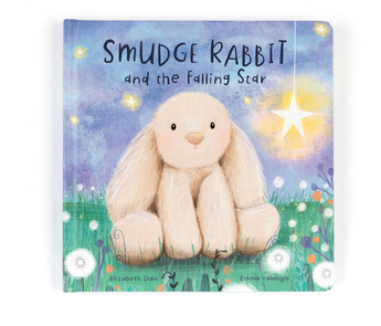 The cover of Jellycat, Smudge Rabbit and the Falling Star Book by Elizabeth Dale and Emma Valenghi shows a fluffy rabbit on grassy land with flowers under a starry sky featuring a glowing star, making it an ideal bedtime story.