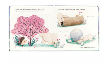 In Jellycats Smudge Rabbit and the Falling Star Book, a hedgehog tells Smudge Rabbit about losing something by a pink tree. Smudge searches around the log and rock, but cant find it.