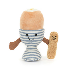 Meet Jellycats Amuse Eggetha Egg & Lance Soldier, a delightful plush duo. The toy resembles a soft-boiled egg in a striped cup with a smiley face and arms, holding Lance Soldier—an equally cheerful toast. Its top features a soft beige exterior with a bright yellow center.