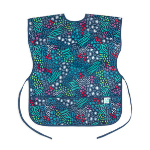 The Bumkins Short-Sleeved Smock features abstract leaf/berry patterns in blue, green, red, white and has an adjustable closure for a perfect fit.