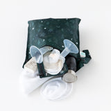 Bumkins Wet Bag: Starry Cactus, with its waterproof green pattern, holds a breast pump, tubes, pads, and a bottle on a white background.