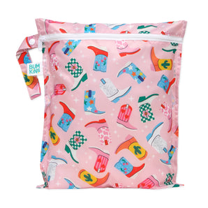 Bumkins Wet Bag: Boots features waterproof fabric with colorful cowboy boot patterns and a snap handle in pink.