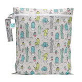 The Wet Bag: Cacti by Bumkins is a reusable bag made from waterproof fabric, showcasing various green, blue, and yellow cacti and succulents on a light background. Its perfect for travel organizers with its zipper and branded tag.