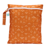 An orange Bumkins Wet Bag: Grounded with white geometric patterns, made from waterproof fabric and a durable white zipper.