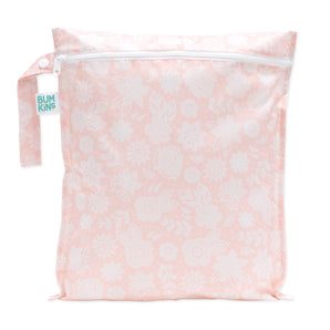 The Bumkins Wet Bag: Lace is a pale pink bag with a subtle white floral pattern, crafted from waterproof fabric. It has a white zipper, a small side handle, and a branded label on the handle, underscoring its quality as one of the best reusable bags for daily use.