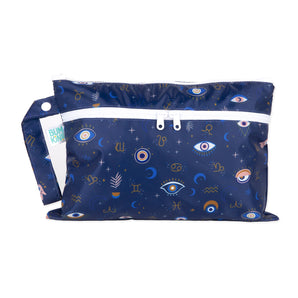 Bumkins Wet/Dry Clutch: Evil Eye in dark blue waterproof fabric, patterned with eyes and stars, has a white zipper and a handy side handle.