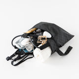 The Bumkins Wet/Dry Clutch: Rich Black lays open on a white background, containing a towel, bottle, and gym gear.