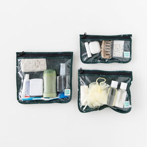 Bumkins Clear Travel Bag 3 Pack: Starry Cactus holds toiletries like toothpaste, deodorant, and spray bottles on a white background.