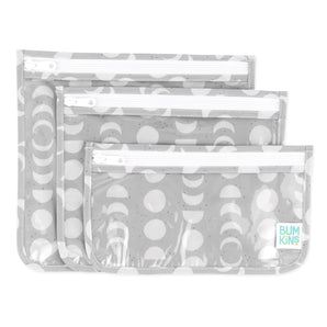 Bumkins Clear Travel Bag 3 Pack: Lunar Phase includes three TSA-compliant pouches with a white lunar phase design on gray waterproof fabric.