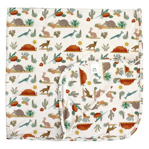 The Emerson and Friends Bamboo Blanket, Desert Friends, features a pattern of kangaroos, cacti, and desert plants.