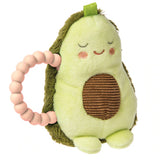 The Rattle, Yummy Avocado by Mary Meyer is a light green plush avocado toy with closed eyes, rosy cheeks, and a smile. It has a brown textured patch seed, fuzzy dark green back, and green handle with pink beads. BPA-free and machine washable, its ideal for little ones.