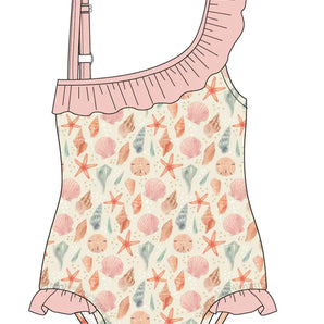 Emerson and Friends One Piece Swimsuit in Sandy Seashells print features a one-shoulder design with pink ruffled trim, seashells, starfish, and coral in pastels on a light background. Small ruffles accentuate the legs of this UV protective swimwear.